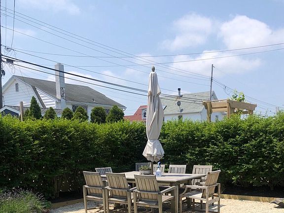 Patio w large teak seating for 10, w patio umbrella and solar lighting. Grill