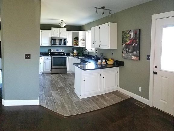 Updated kitchen with stainless steel appliances and pantry