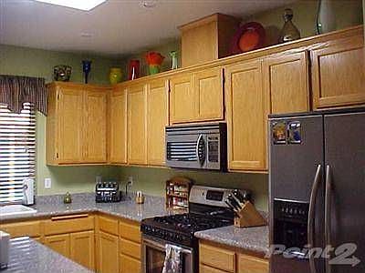 Oak cabinets, stainless steel appliances, and granite counters make this kitchen shine!