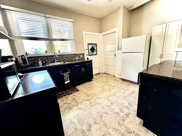 Recently renovated kitchen. Dishwasher and oven replaced in 2025. New granite counter tops and flooring 2023. New blinds and paint. There is a large cabinet next to refrigerator that functions as a pantry. Main-level laundry room attached.