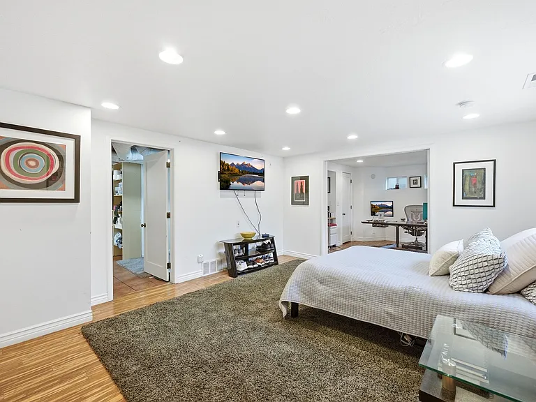 Main room on the lower level. Can be used as additional family room with adjacent bedroom and bathroom or as a master suite and office as pictured.
