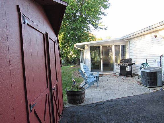 Rear sun room, patio and she