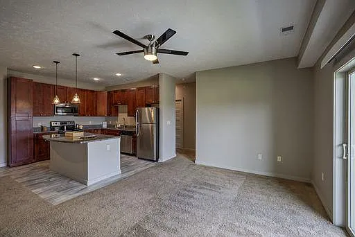 Open concept living room with balcony doors.