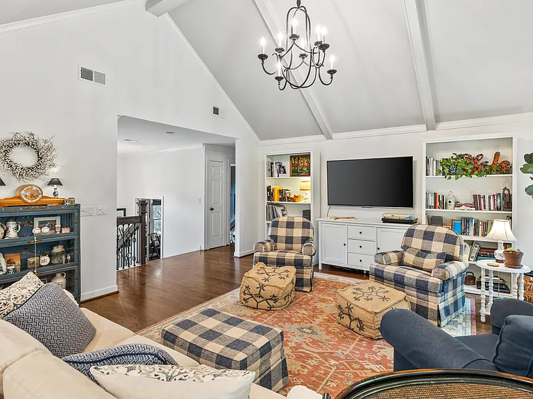 Spacious and bright living room at the top of the foyer stairs. Enjoy plenty of seating, a Smart TV, and lots of natural light.