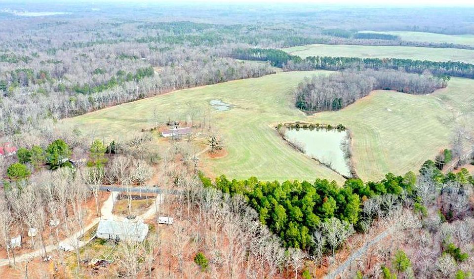 This photo is taken is the western most end of the property looking north east over the home and the 1.20 acre pond.