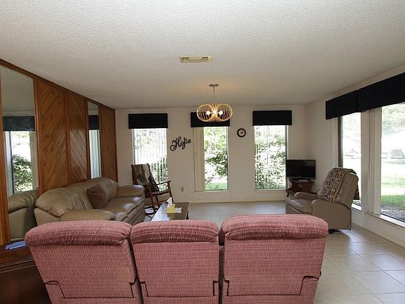 Here s another look at the Living Room showing all the windows overlooking the front yard.