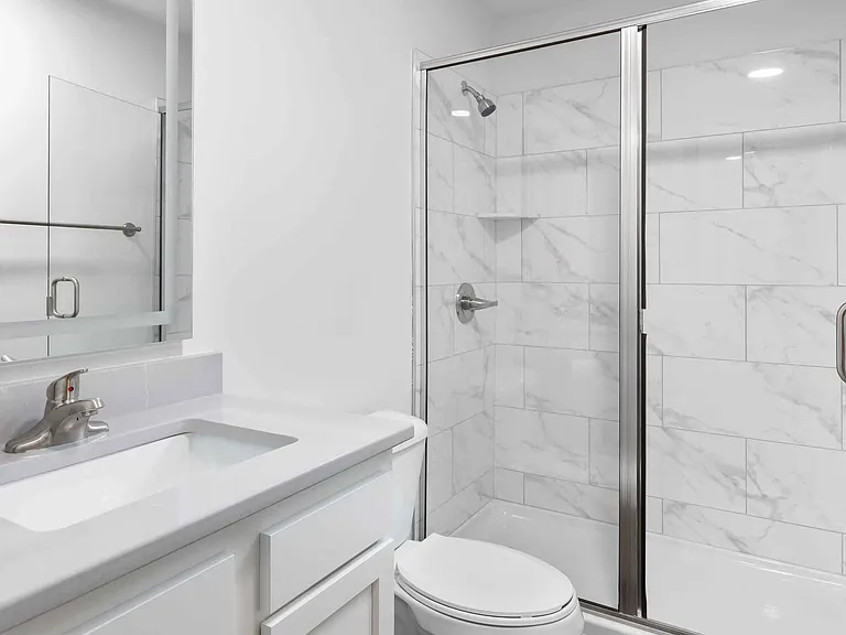 Bathroom with walk-in shower and quartz vanity
