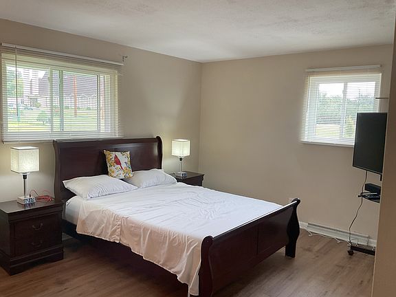 Master bedroom with 2 endtables, dresser, cabinet, mirror, Roku TV and attached full bathroom. New 12" Zinus queen memory foam mattress and all furniture new.