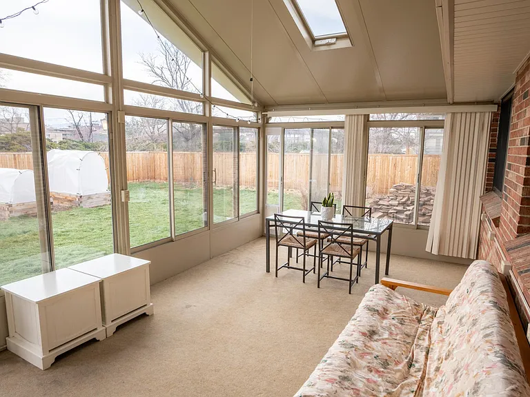 The sun room provides a wonderful space to enjoy the garden and views of the Flatirons.