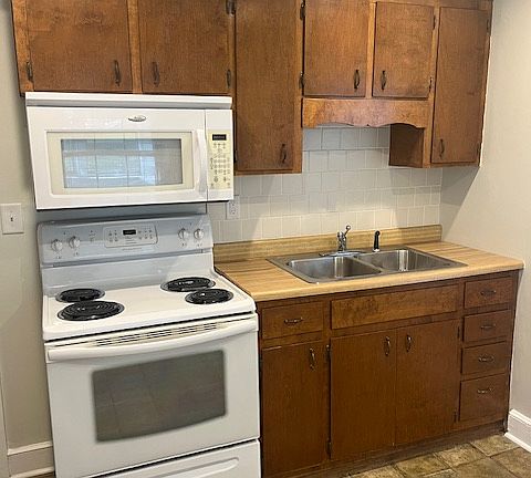 Kitchen double sink, stove/oven and microwave