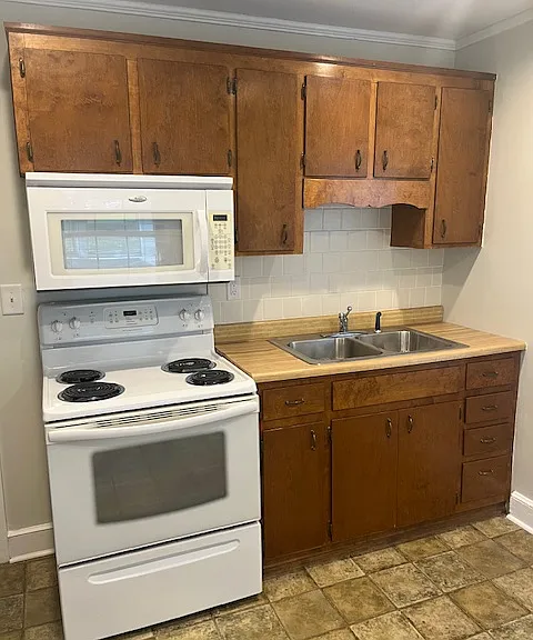 Kitchen double sink, stove/oven and microwave