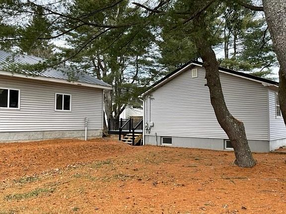 House to right, oversized garage to left, deck can be seen in between