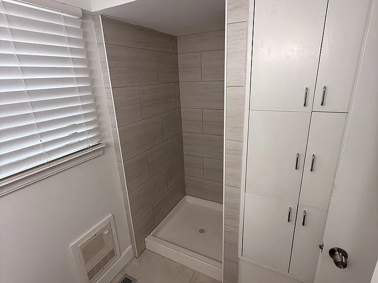 Main floor bath with new shower tile and lots of cabinet storage