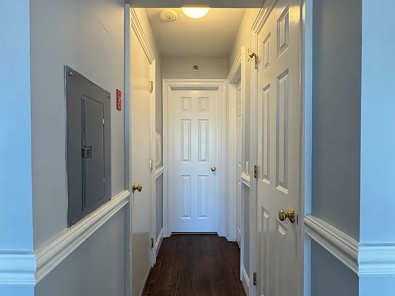 Hallway leading to bedroom, bathroom, and some closet space