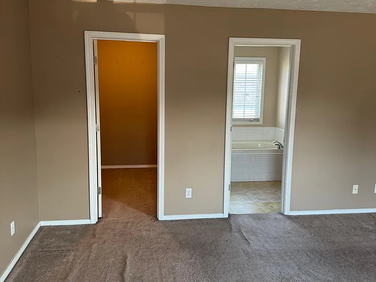 Looking at closet (right door) and bathroom(left door) from the window of the master bedroom