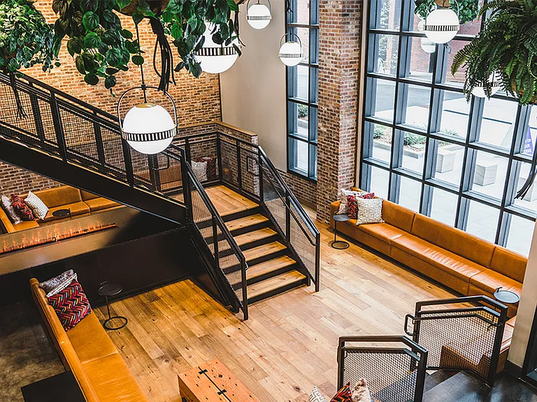 Stunning two-story lobby and seating area with green space