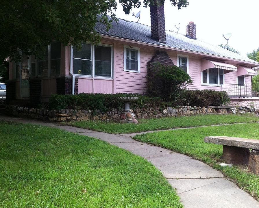 paved walkway with stone benches and bird baths