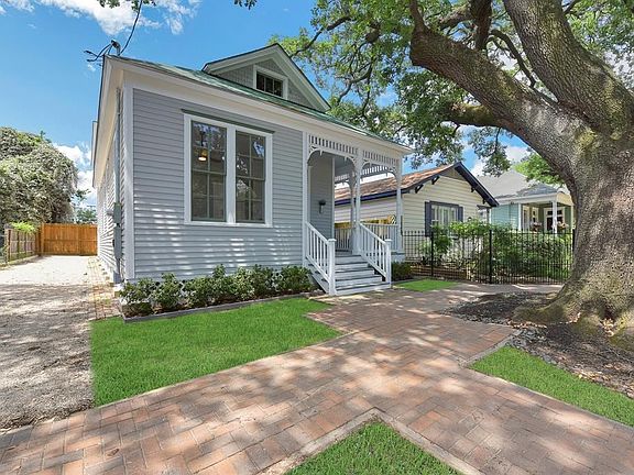 Side view of the property with drive way leading to attached garage.