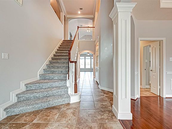Grand entryway with study and half bath to the left and formal dining to the right.