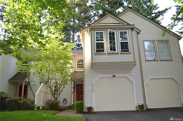 Front view of the home. One car garage with parking in front.