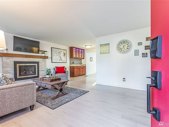 Step inside to this swoon worthy living area with gas fireplace built into a limestone surround.