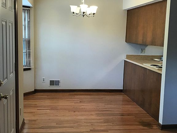 Dining area with bay window & dimmable light fixture.