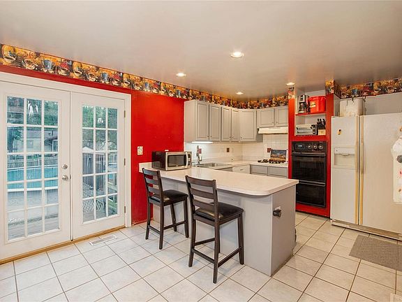 Great size eat in kitchen with french doors leading to the backyard with above ground pool and firepit area