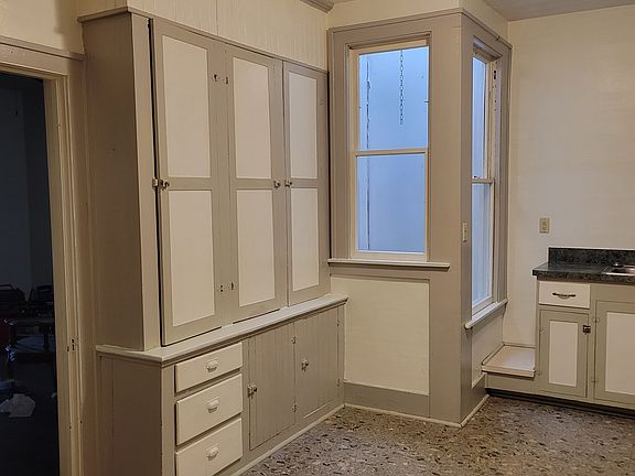 View of kitchen from entryway. Large built in cabinet for plenty of storage. Built in skylight allows plenty of natural light. Window does open to place some flower boxes but you will need to water them