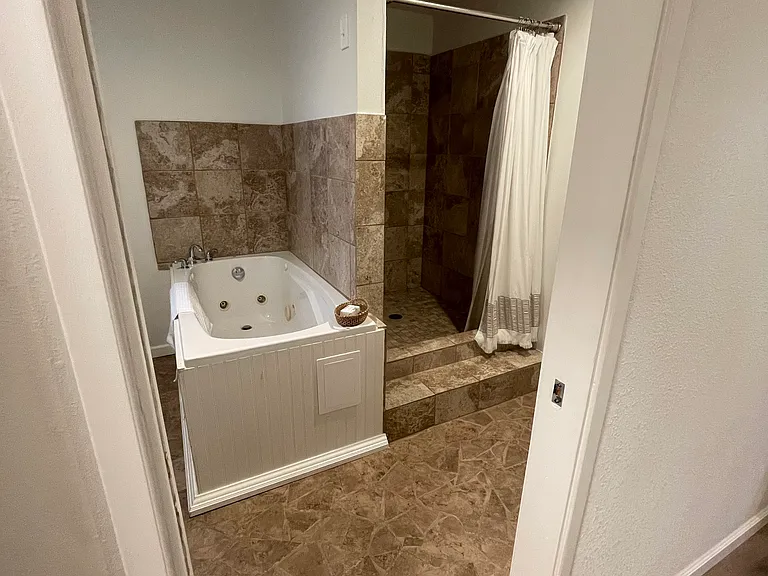 Downstairs bathroom with large shower and jetted tub