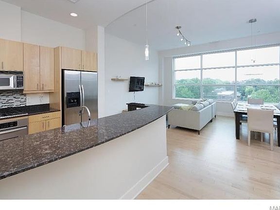 Open floor plan, 11 foot ceilings, stainless steel appliances, granite counter tops, breakfast bar, wood floors and gorgeous view.