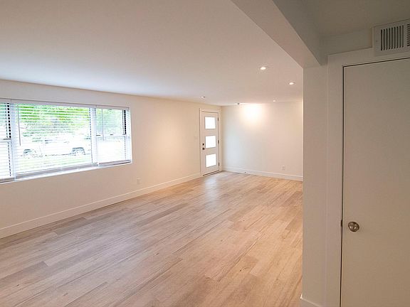 Large windows flood the living room with light. 
All new lighting & flooring throughout.