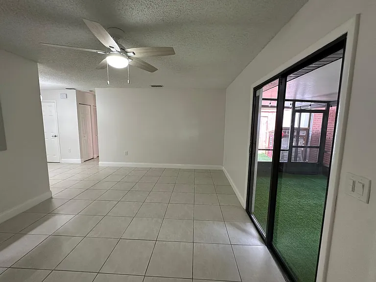 LIVING ROOM, 
VIEW OF SLIDING DOOR LOOKING INTO COVERED PORCH AREA.