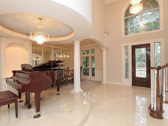 WELCOME TO THIS LOVELY CHAMPION FOREST HOME, BUILT FOR ENTERTAINING AND ENJOYING LIFE - Tickle the ivories while you entertain your family and friends during your favorite holidays and gatherings. The marble flooring adds sophistication and class as 
