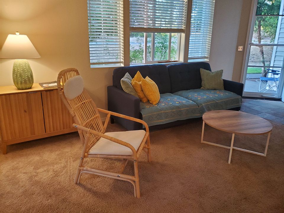 one seating area showing front door and landscaping outside windows