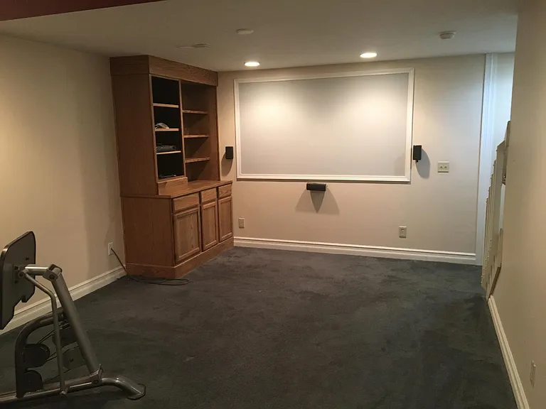 Finished basement with projector screen