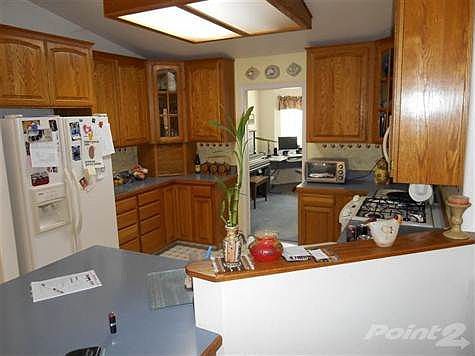Nice country kitchen next to the dining room and it looks into the family/front room area.