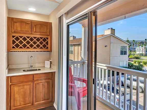 Wet bar for entertaining and enjoying the balcony that overlooks the pool area.