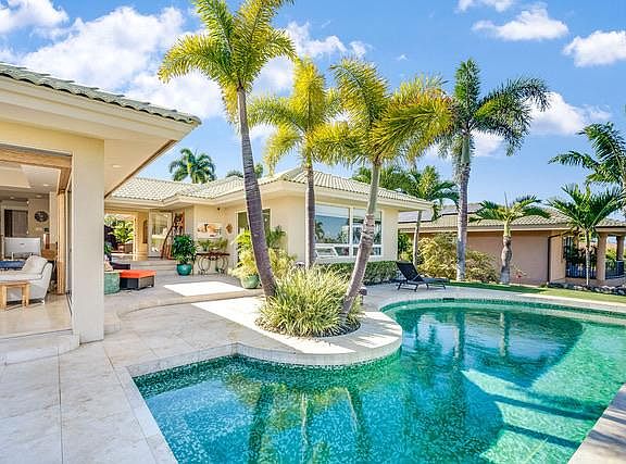 Living room on the left with fully retractable glass sliders. Center area is the rear courtyard and right side is the master suite.