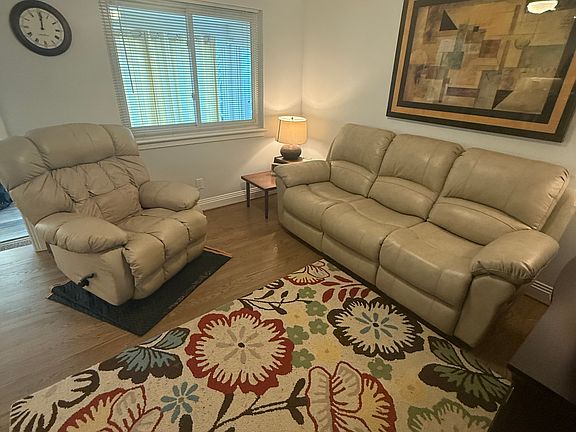 Main living area with leather sofa and recliner