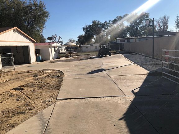 Front drive way with gate / basket ball hoop