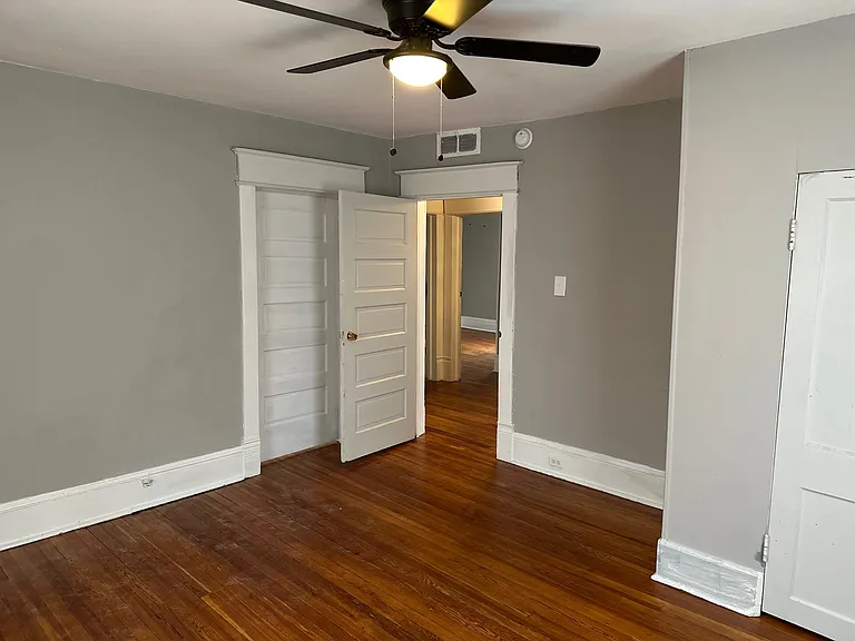 Bedroom One w/ Designer Ceiling Fan and Newly Refinished Hardwood Floors and Designer Paint.