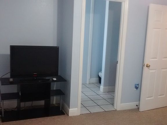 1st bedroom view of bathroom and to the right is exit to stairway