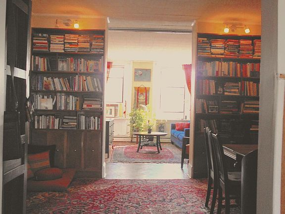 Dining room with built in bookshelves - living room seen in the back