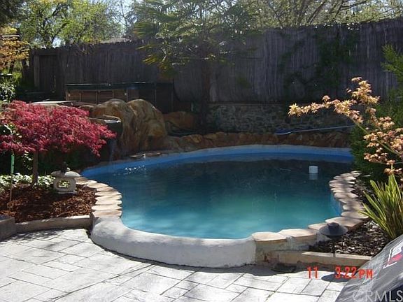 Inground pool with water fall.   Hot tub as well.
