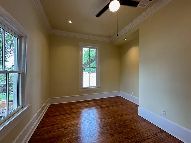 Light comes from both north and west windows into the second bedroom.