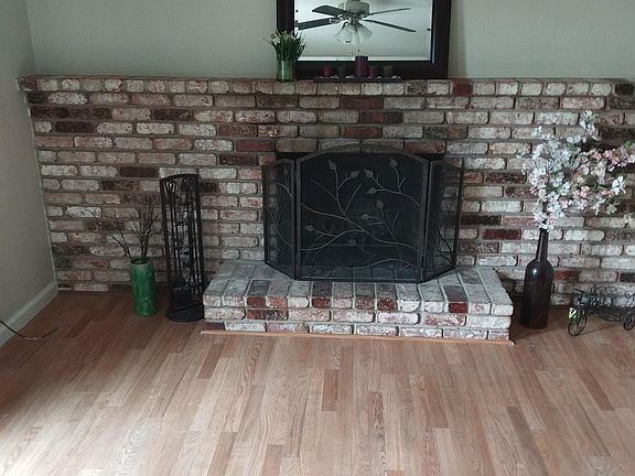 Den/living room/formal dining room. Has sliding doors to go to back yard. Wood-burning fireplace. Ceiling fan.