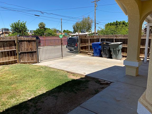 Front yard with gated driveway.