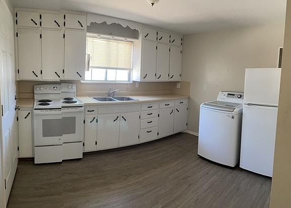 Kitchen with oven/stove, refrigerator and clothes washer. Dryer is in outside shed outside kitchen door.