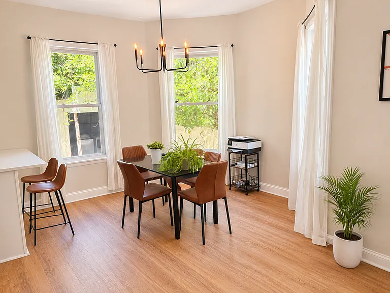 Dining area with table and chairs as well as barstools for casual dining or visiting with the chef.