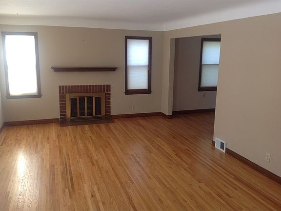 Living room with fireplace, dining room, and family room all